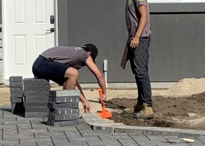 Workers working with pavers